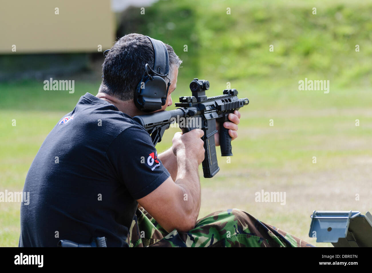 Ballykinlar, Northern Ireland. 2nd August 2013 - A man fires a Colt M4A1 Credit:  Stephen Barnes/Alamy Live News Stock Photo