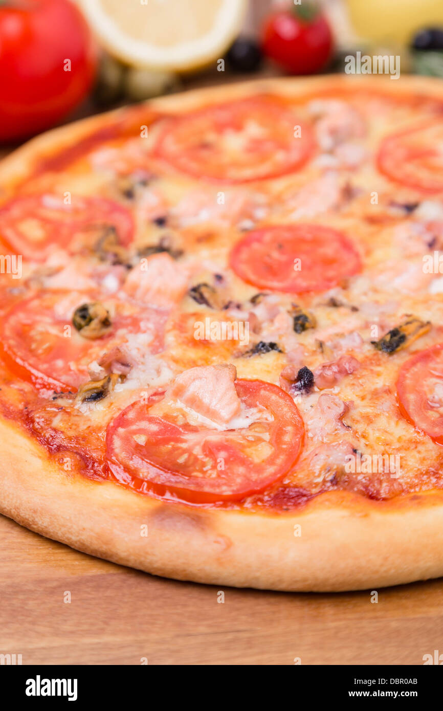 hot pizza with garnish and ingredients Stock Photo Alamy