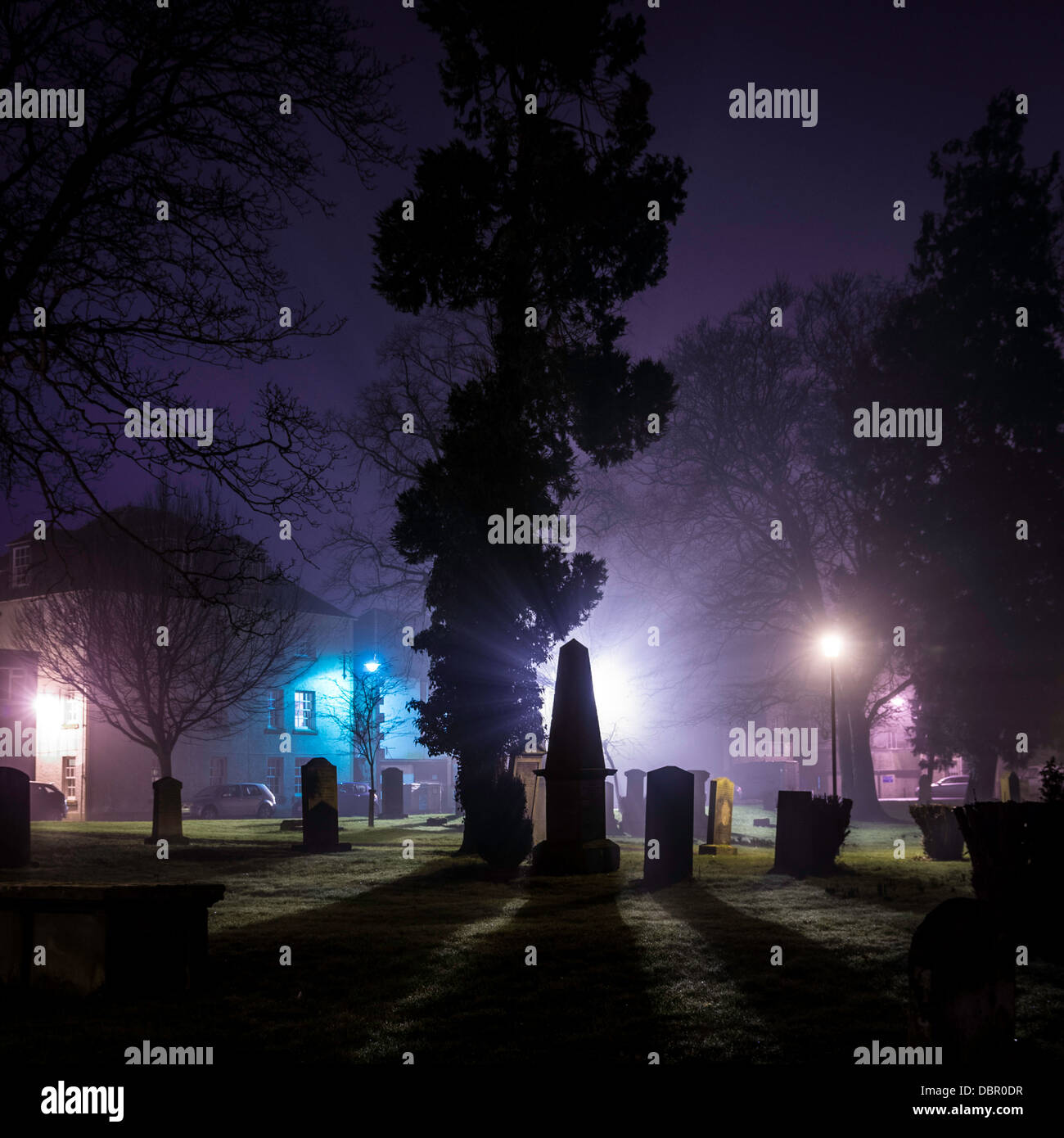 Gravestones outside Kelso Abbey taken on a misty night in the Scottish Borders Stock Photo