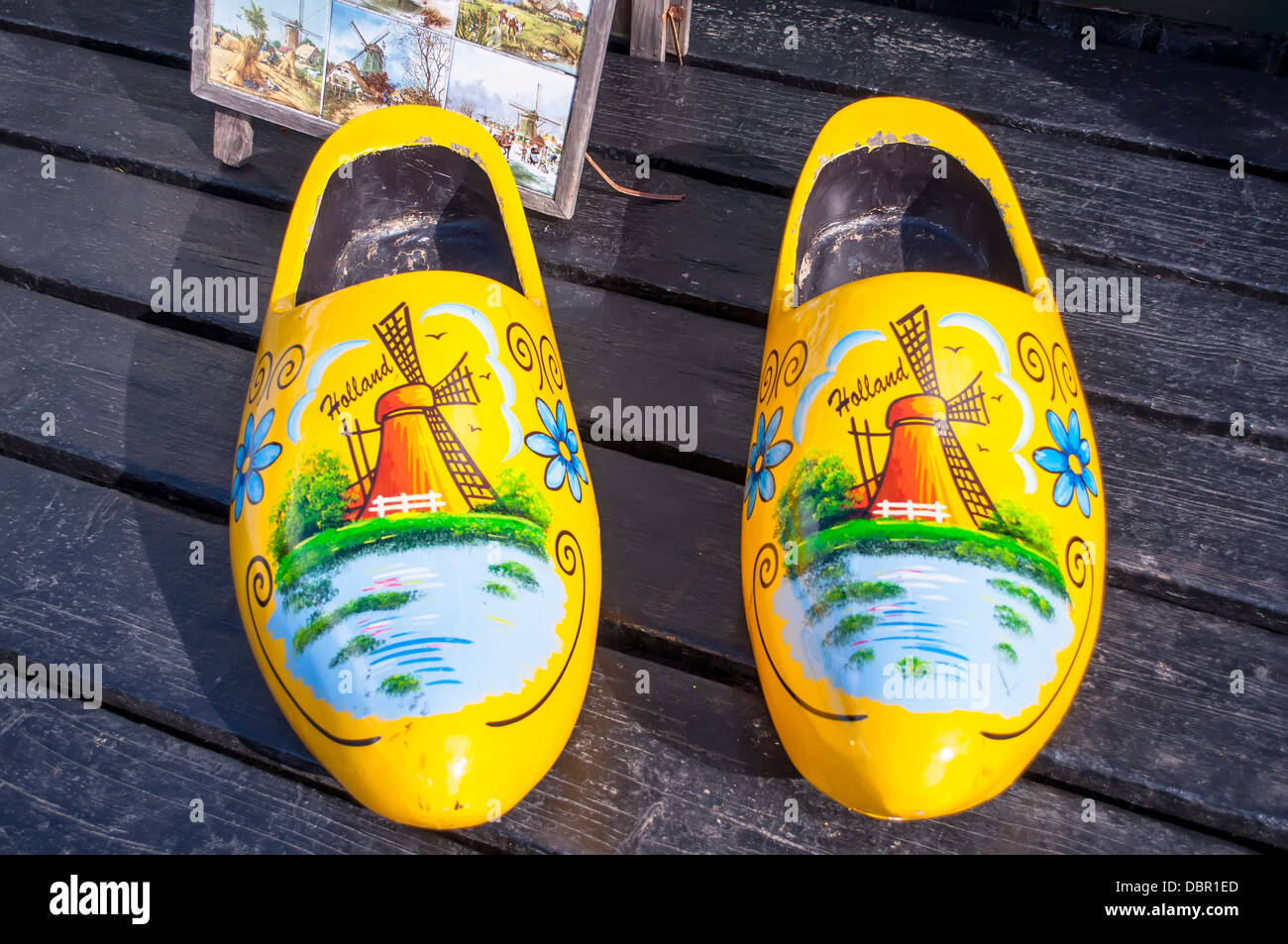 Traditional Dutch wooden clogs with drawings and yellow Stock Photo - Alamy
