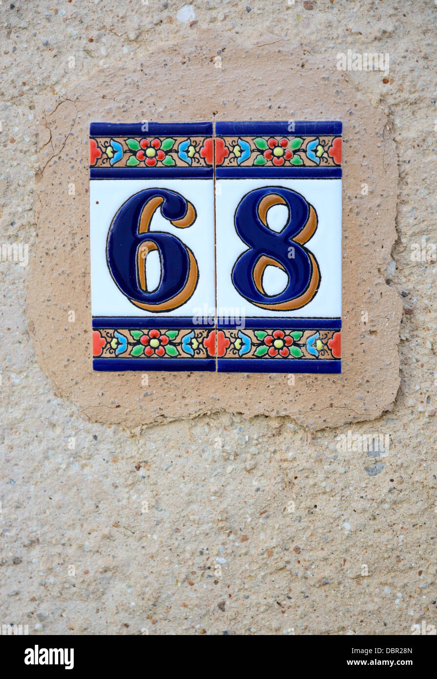 Ceramic tile ibiza style with the number '68' on a wall Stock Photo