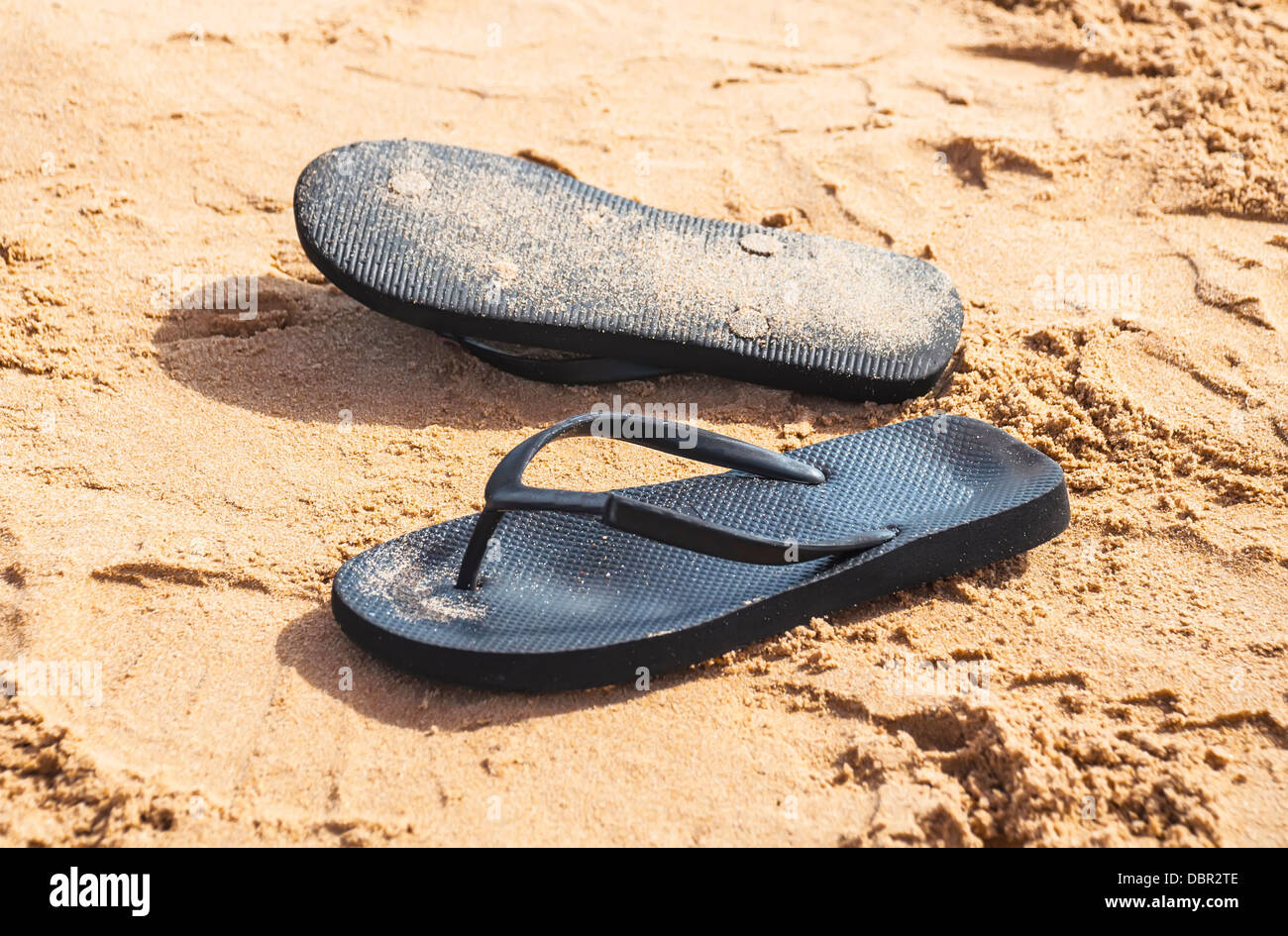 Summer Sandals in the sand on the beach Stock Photo - Alamy