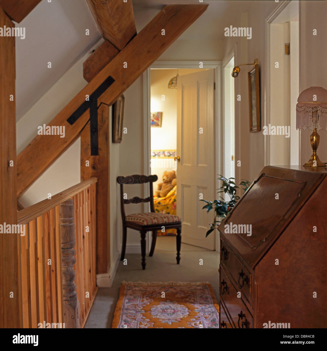 Fishing rods and equipment on wall above large basket on old painted chest  on cottage landing Stock Photo - Alamy