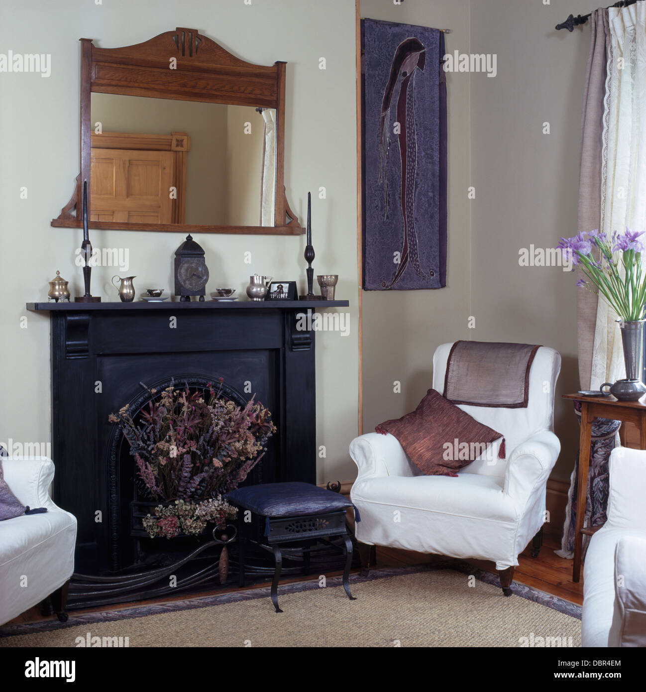 Edwardian wood framed mirror above black fireplace in small white