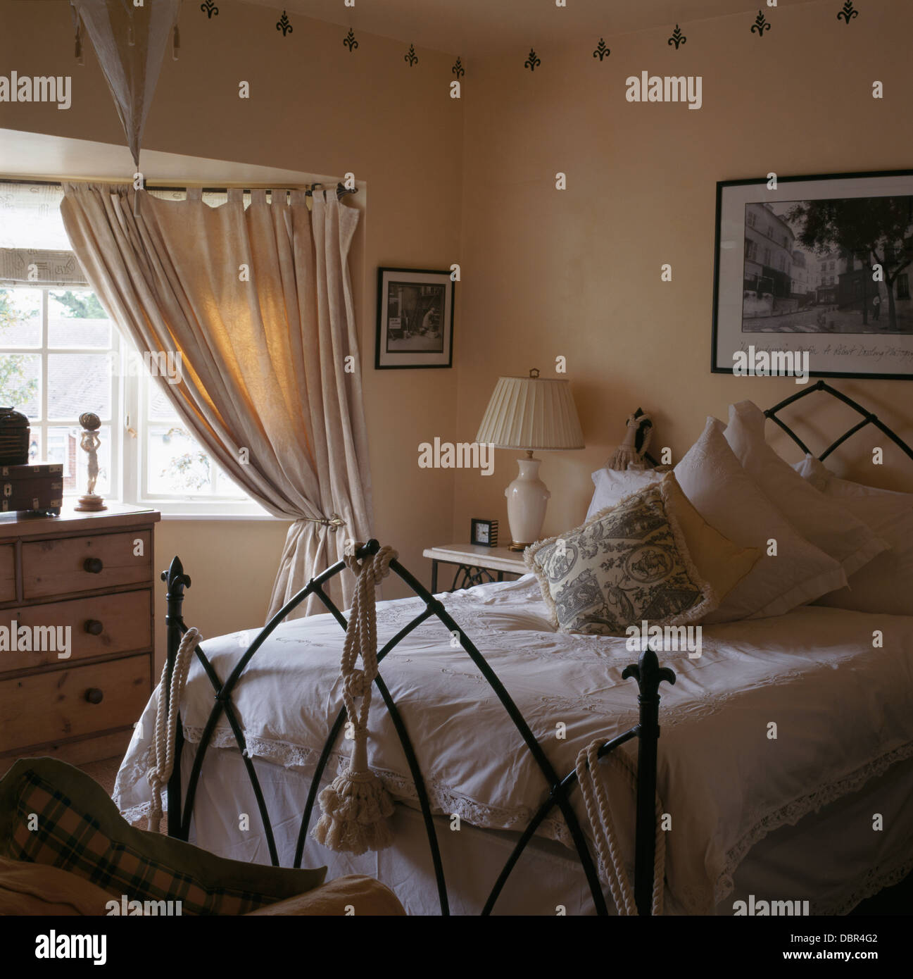 Gothic Style Wrought Iron Bed With White Pillows And Lace Edged