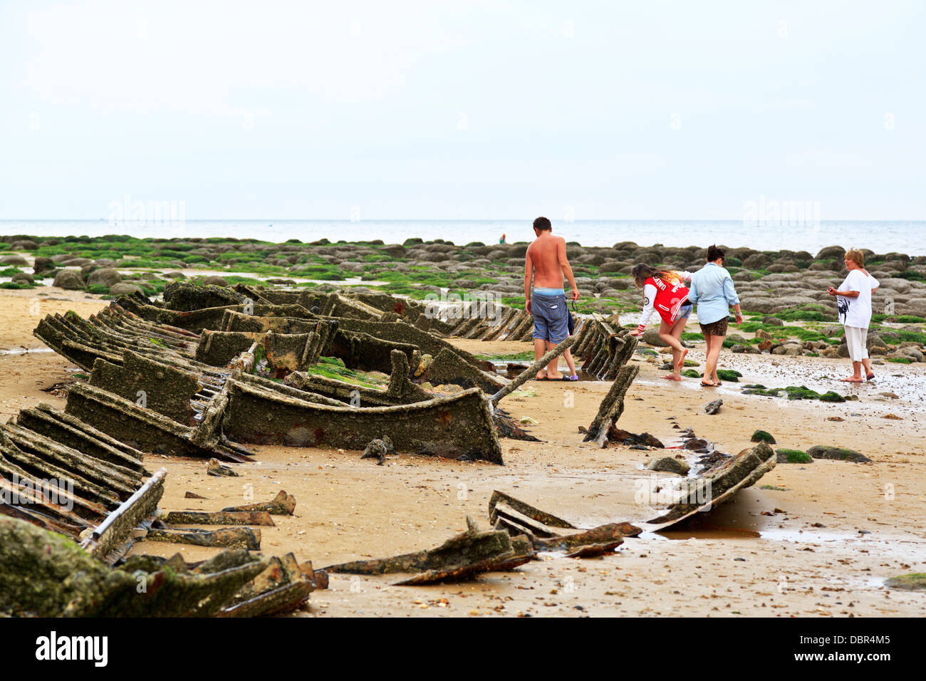 People inspecting the remains of a wrecked boat at Hunstanton beach
