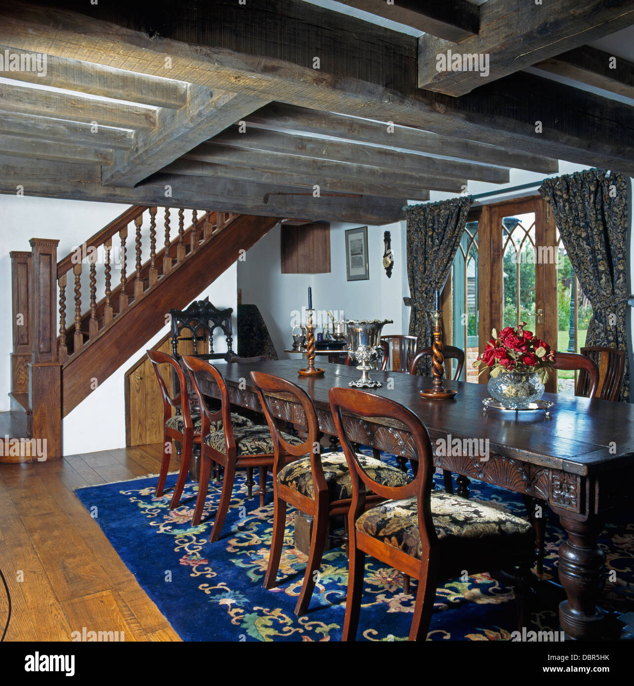 Balloonback chairs and Jacobeanstyle table in beamed dining room in