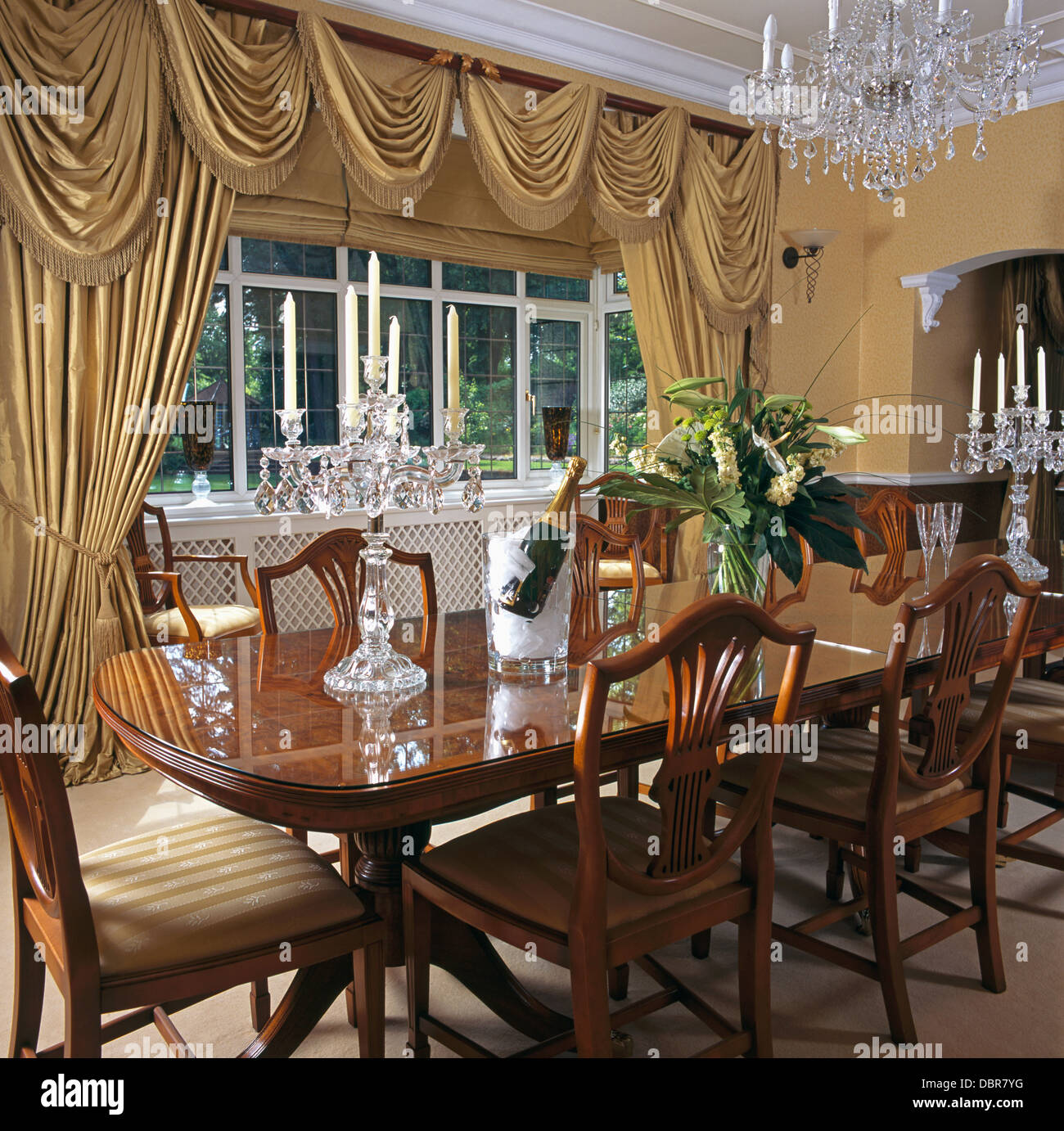 Regencystyle table and chairs in country dining room with beige silk