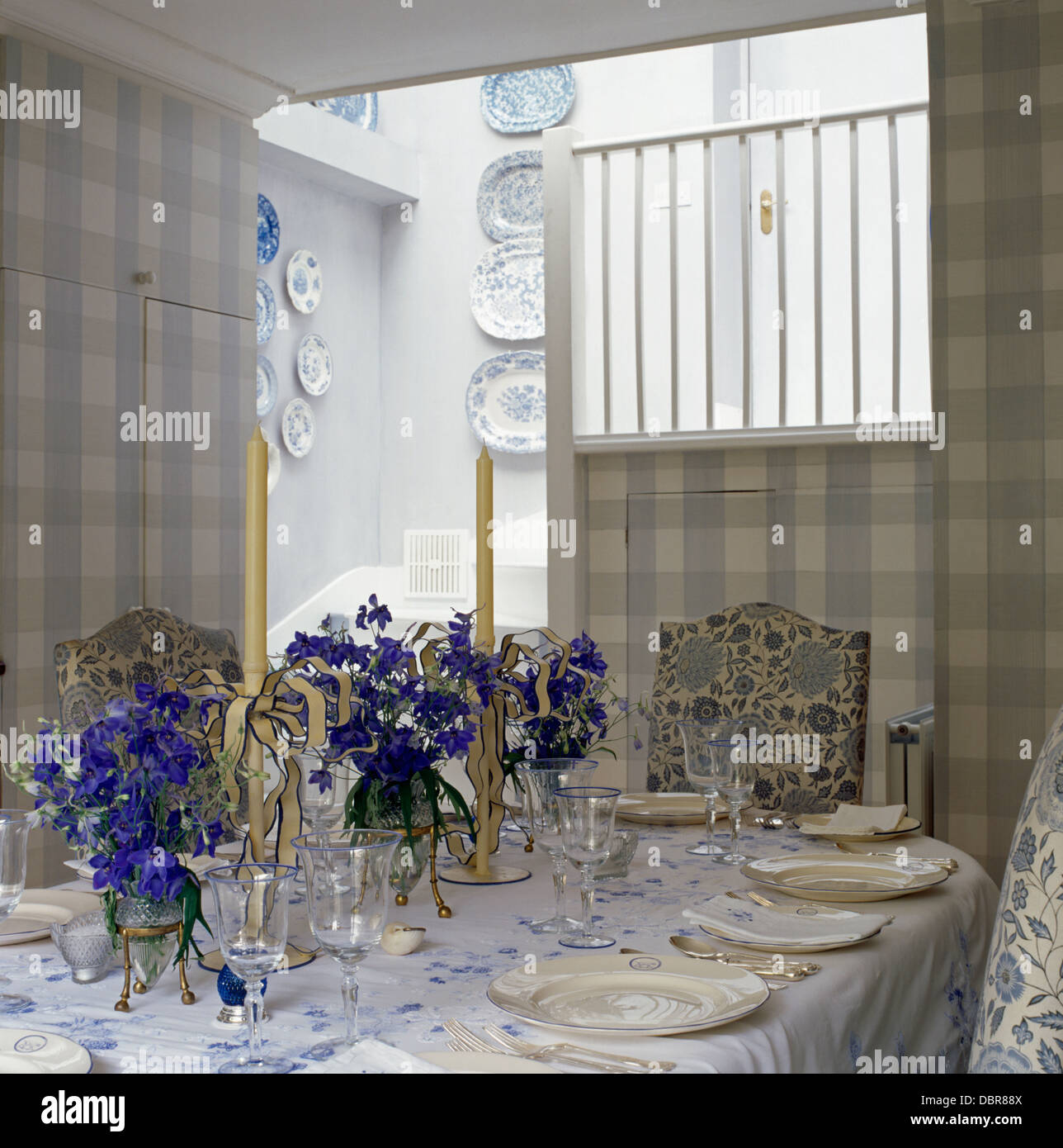 Blue Flowers In Small Vases On Table Set For Lunch In