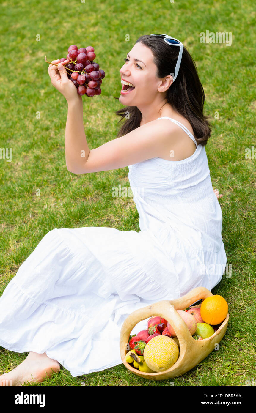 Woman in a park with rustic fruits basket Stock Photo - Alamy
