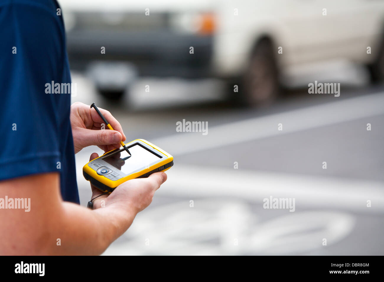 A man uses a handheld GPS unit to navigate Stock Photo Alamy