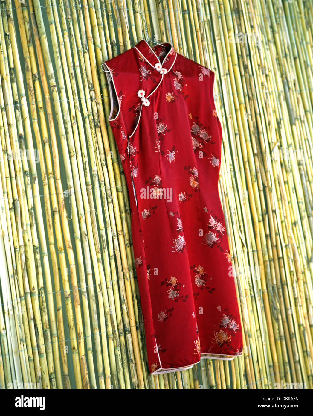 Close-up of red silk Chinese cheomsang on bamboo screen Stock Photo