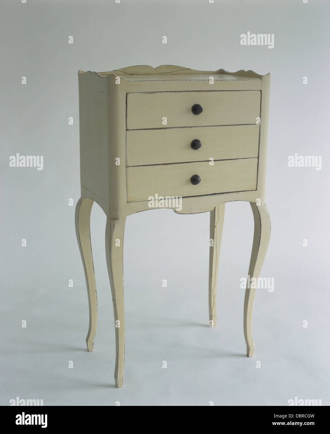 Close Up Of Painted Small Chest Of Drawers On Tall Legs Stock