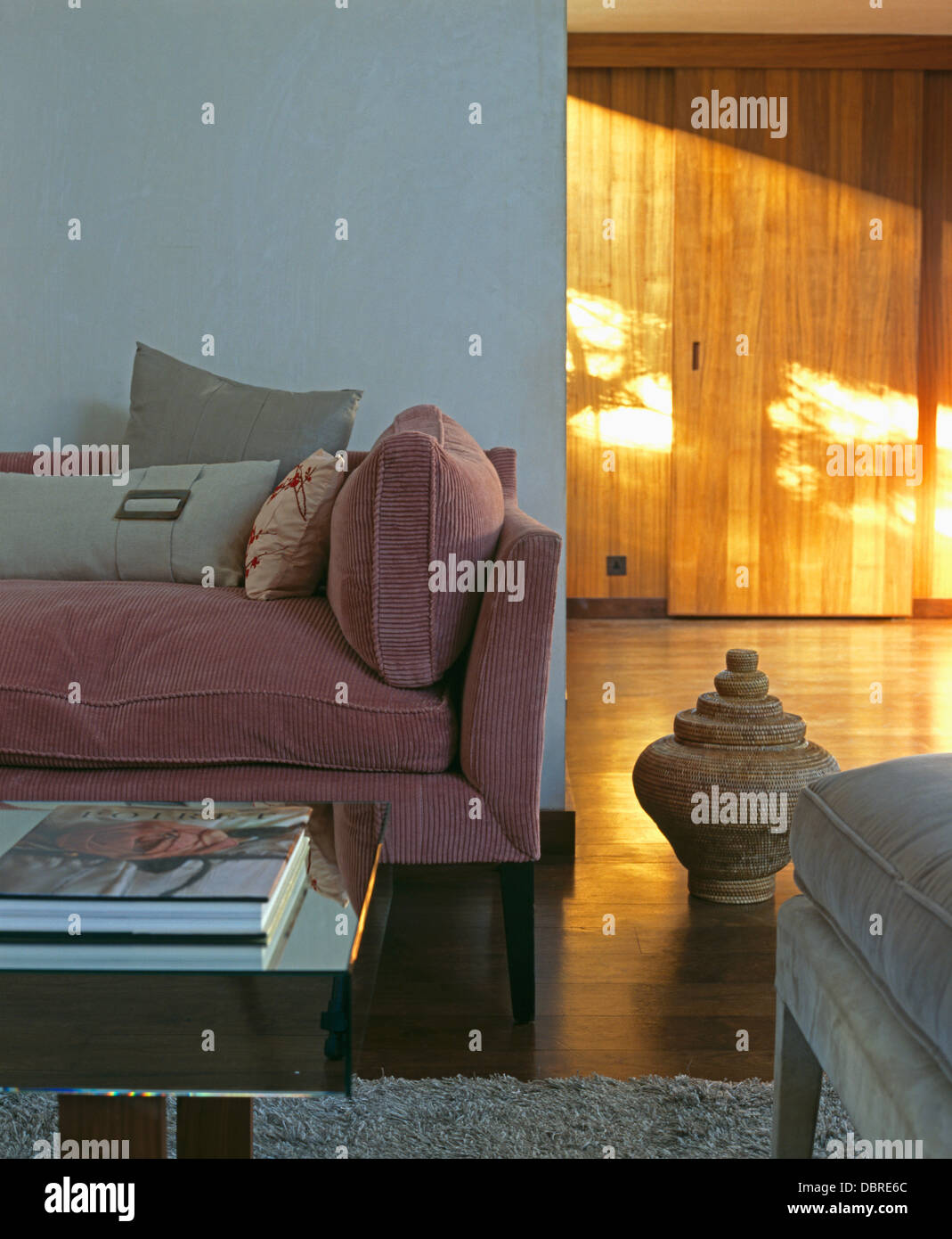 Pink Corduroy Sofa With Gray Cushions In Loft Conversion Living Room With Large Terracotta Pot On Wooden Floor Stock Photo Alamy