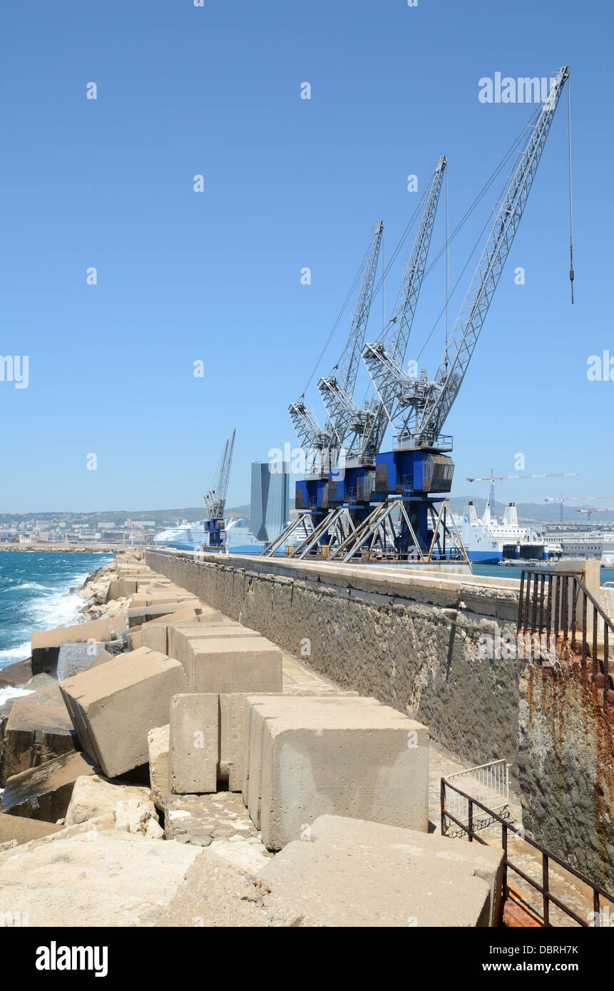 Seawall Break Water Breakwater or Sea Defenses with Concrete Blocks Revetments & Cranes at Marseille Docks Harbour or Port Marseille France Stock Photo