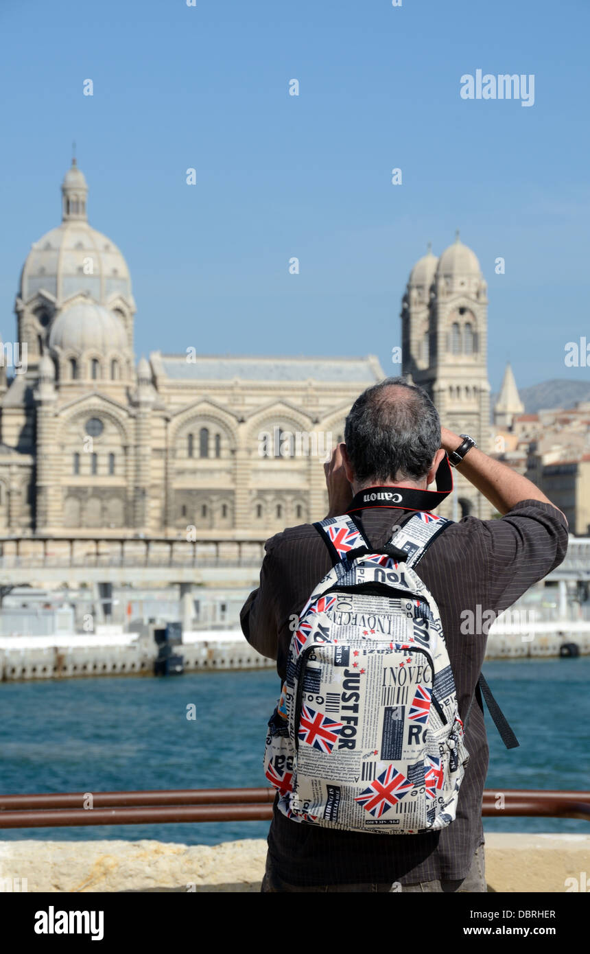 Senior Tourist Photographer with Globe Trotter Rucksack, Backpack or Daypack Photographing Marseille Cathedral Marseille Provence France Stock Photo