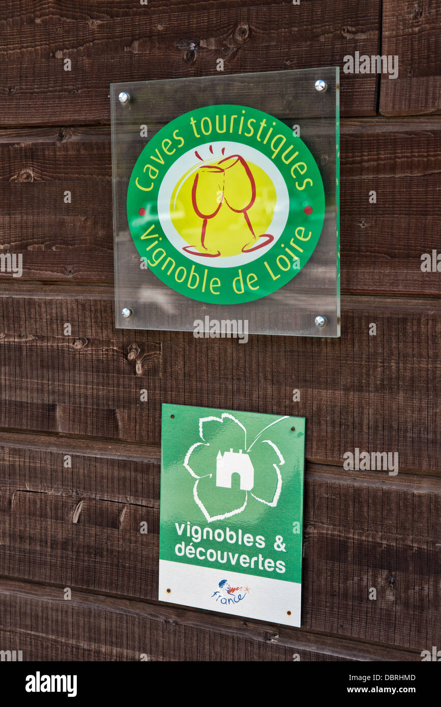 Signs on a wall denoting membership of 2 French wine trade organizations & tourism initiatives in the Loire valley France Stock Photo