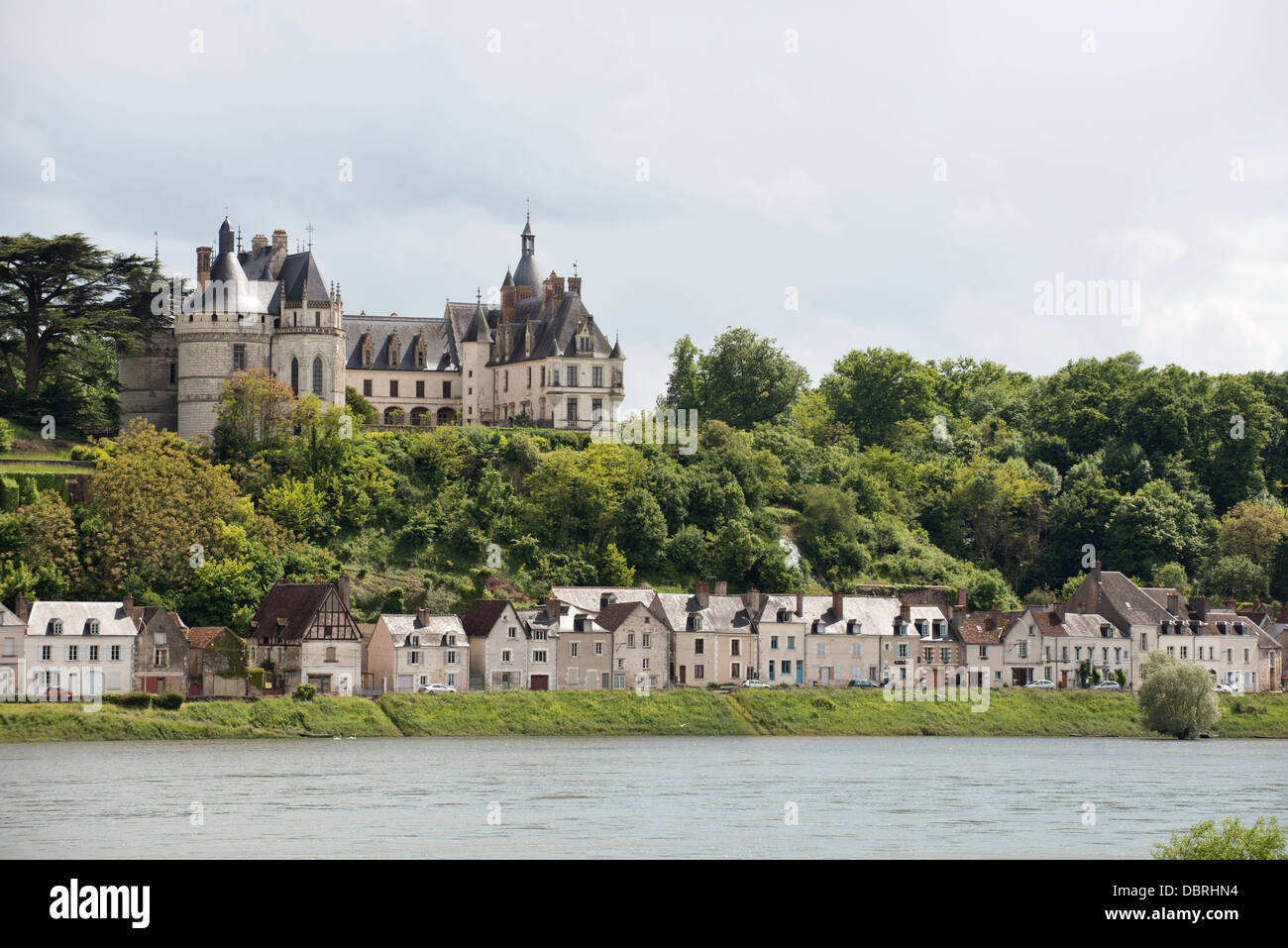 A view of the historic French Château Chaumont with the towns cottages nestled beneath from across the river Loire, France Stock Photo