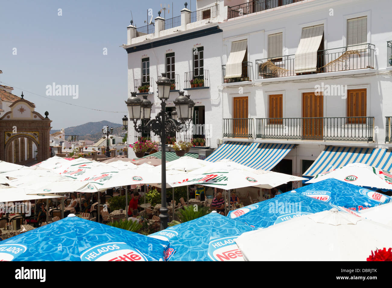Umbrellas providing shade to tourists eating and drinking in the town ...
