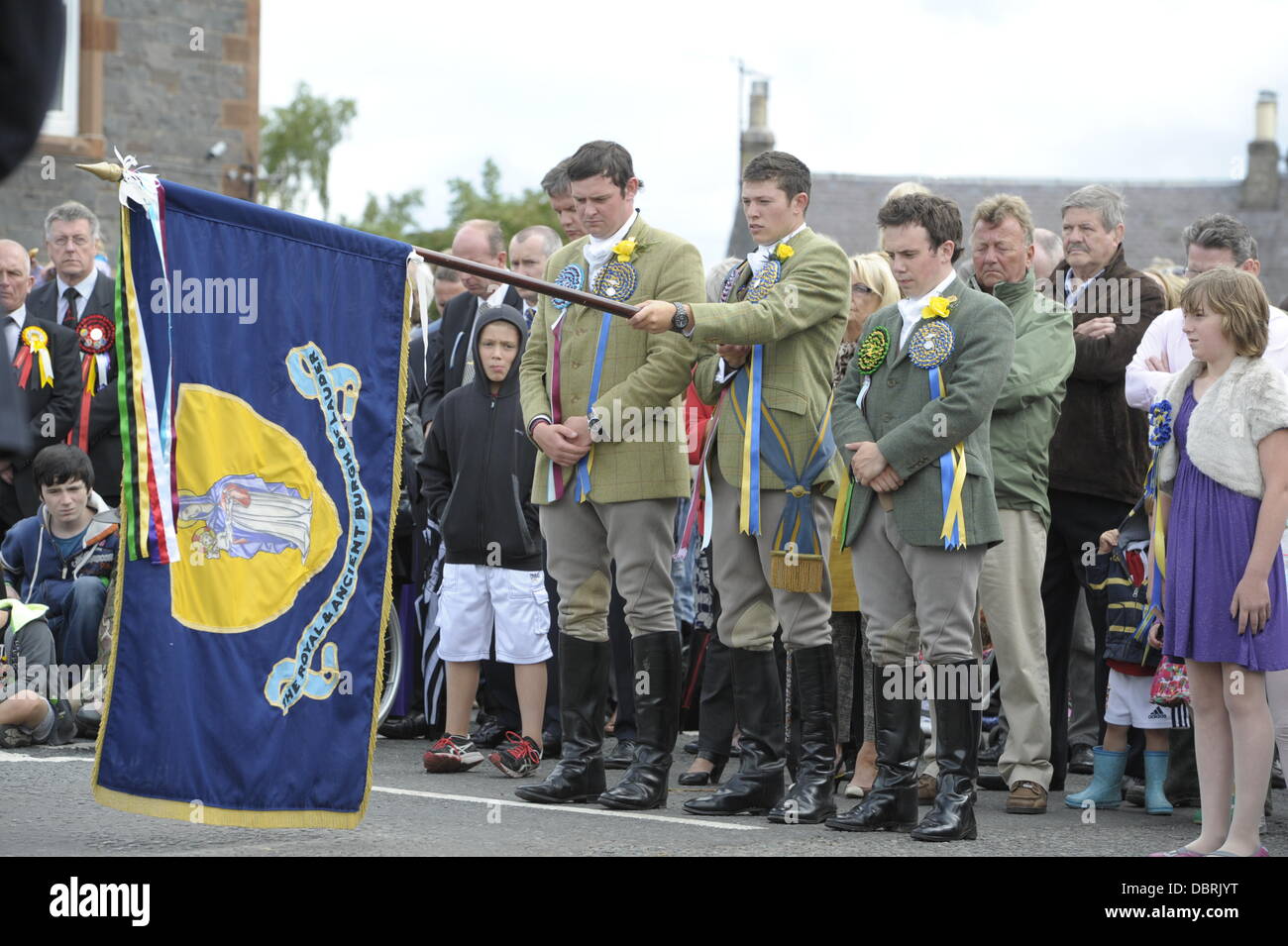 Lauder, UK. 3rd August, 2013. Lauder Common Riding 2013 - the traditional annual inspection of the border markings of the town. Pictured: Ceremonies at the War Memorial at the War Memorial to remember the fallen. One of the original Border Common Ridings, there is a reference to a ceremony in Lauder's Town Council minutes of 1686. On Saturday the Cornet receives the Burgh Flag at the Tollbooth and leads the mounted cavalcade to the Watering Stane and onto the Burgess Cairn, the only boundary stone still in existence. Stock Photo