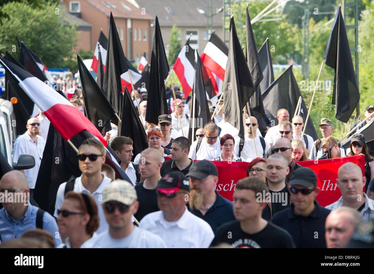 Bad Nenndorf, Germany. 03rd Aug, 2013. Participants to a neo-Nazi rally in Bad Nenndorf, Germany, 03 August 2013. A large group of people formed before to protest against a neo-Nazi rally. Photo: SEBASTIAN KAHNERT/dpa/Alamy Live News Stock Photo