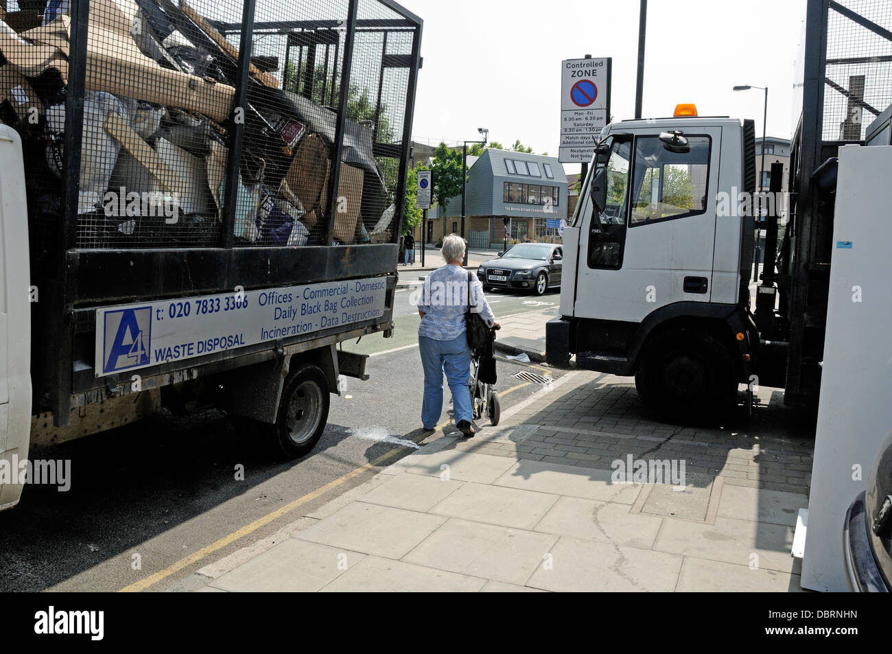 Lady or woman forced to walk in the road by waste disposal vehicles ...