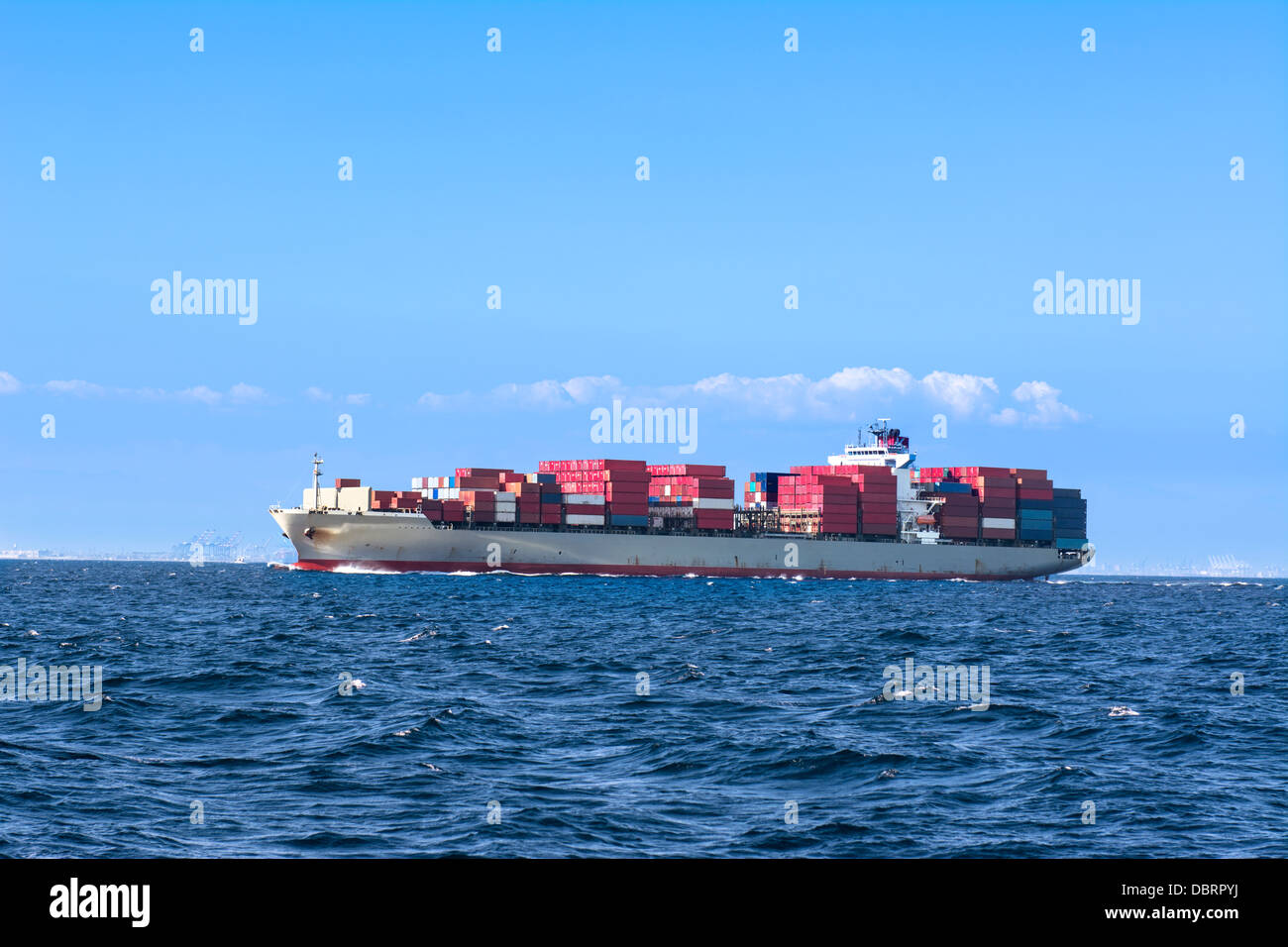 A freighter loaded with cargo containers leaves the port of Long Beach