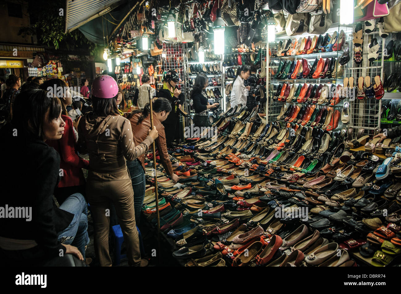 HANOI, Vietnam Vietnamese women look at the shoes for sale at a shoe