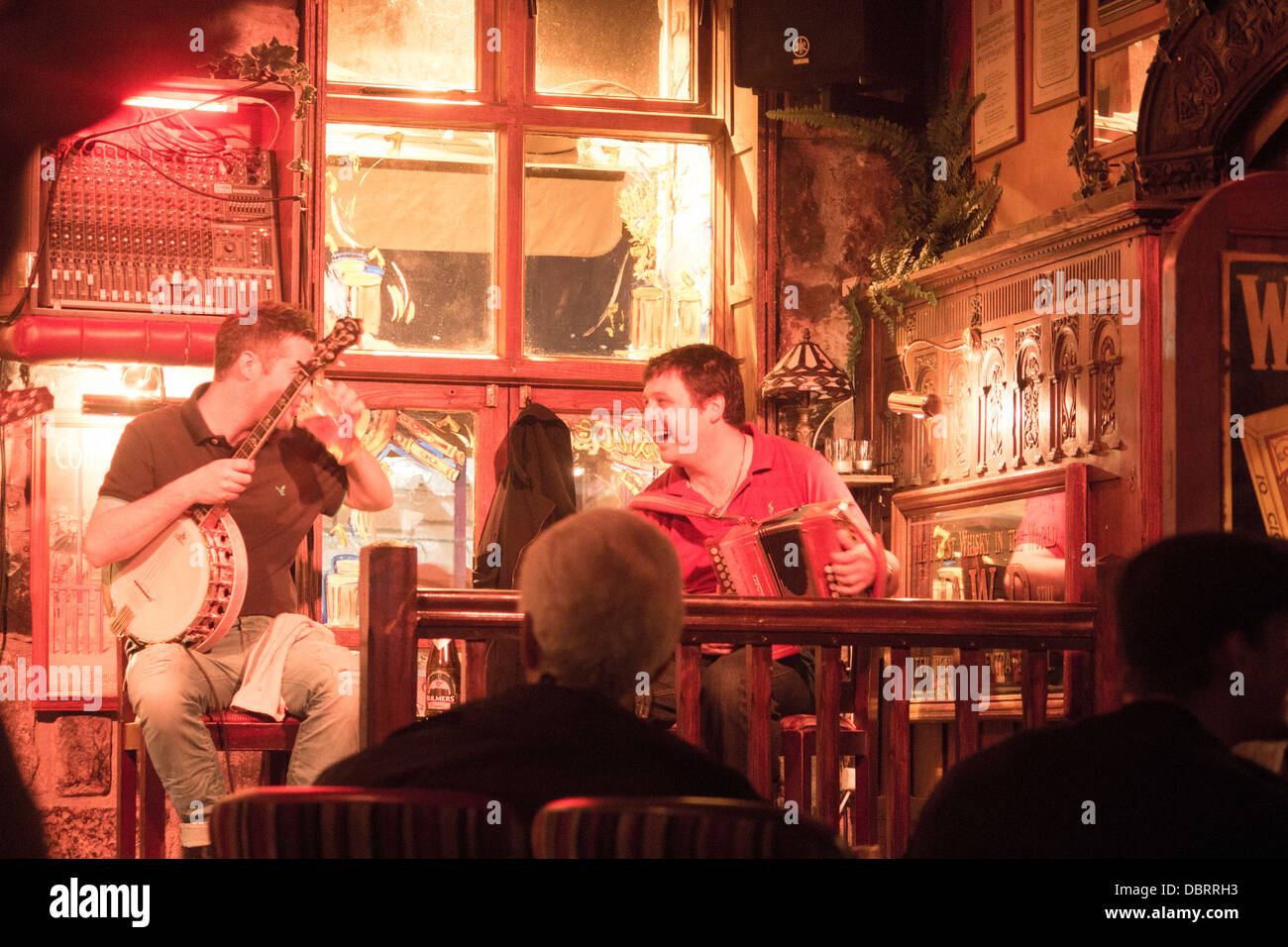 Musicians laughing and sharing a joke in between songs during a traditional Irish music set Galway Eire Republic of Ireland Stock Photo