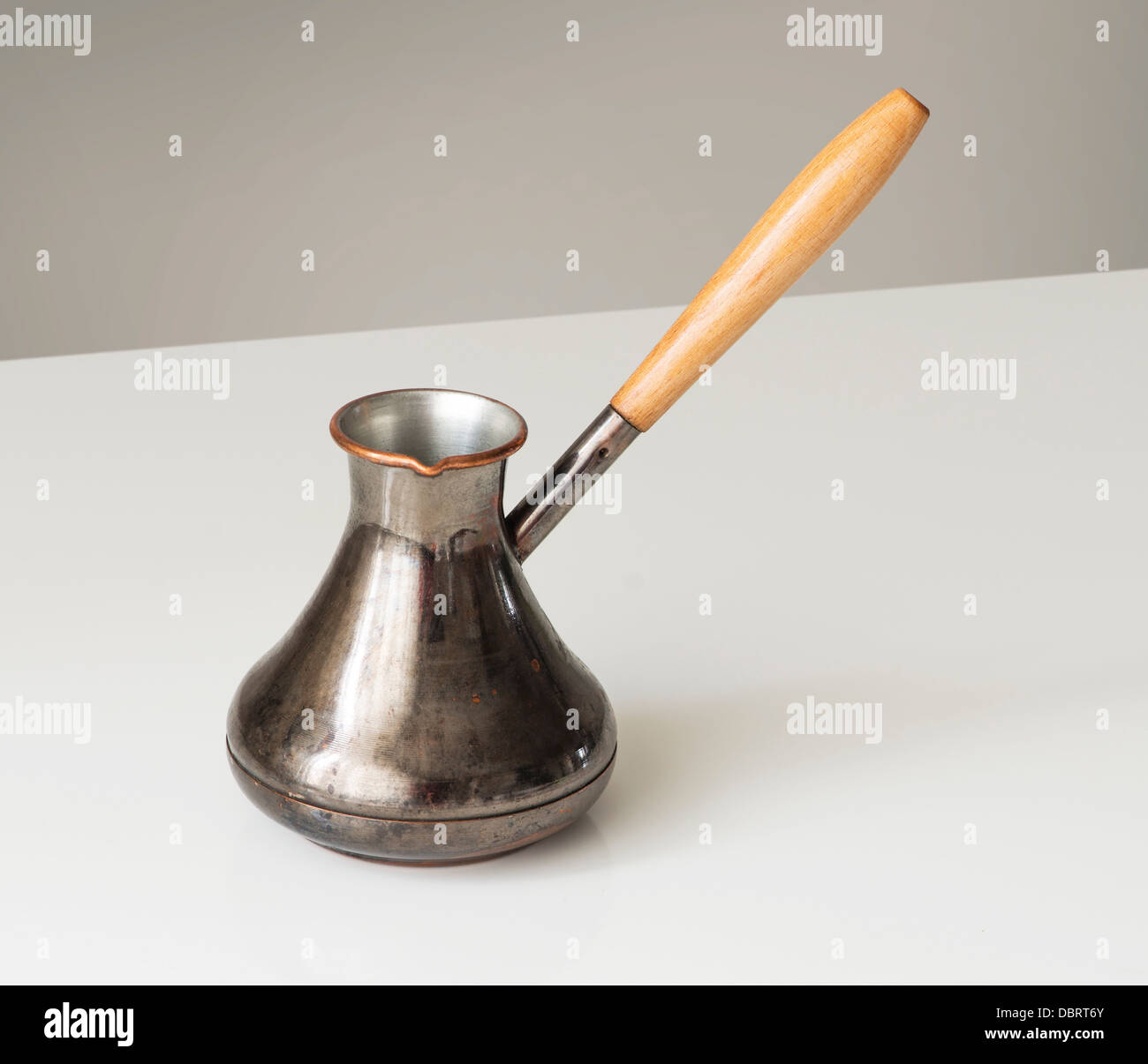 Copper turkish coffee pot  on white table, clipping path Stock Photo