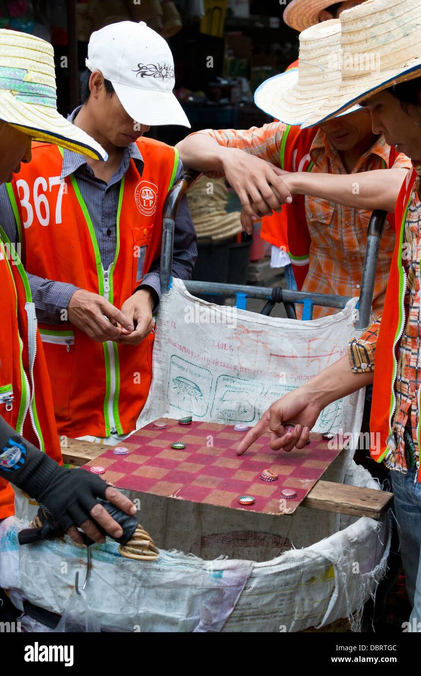 Playing a Board Game on the Klong Toey Market in Bangkok, Thailand