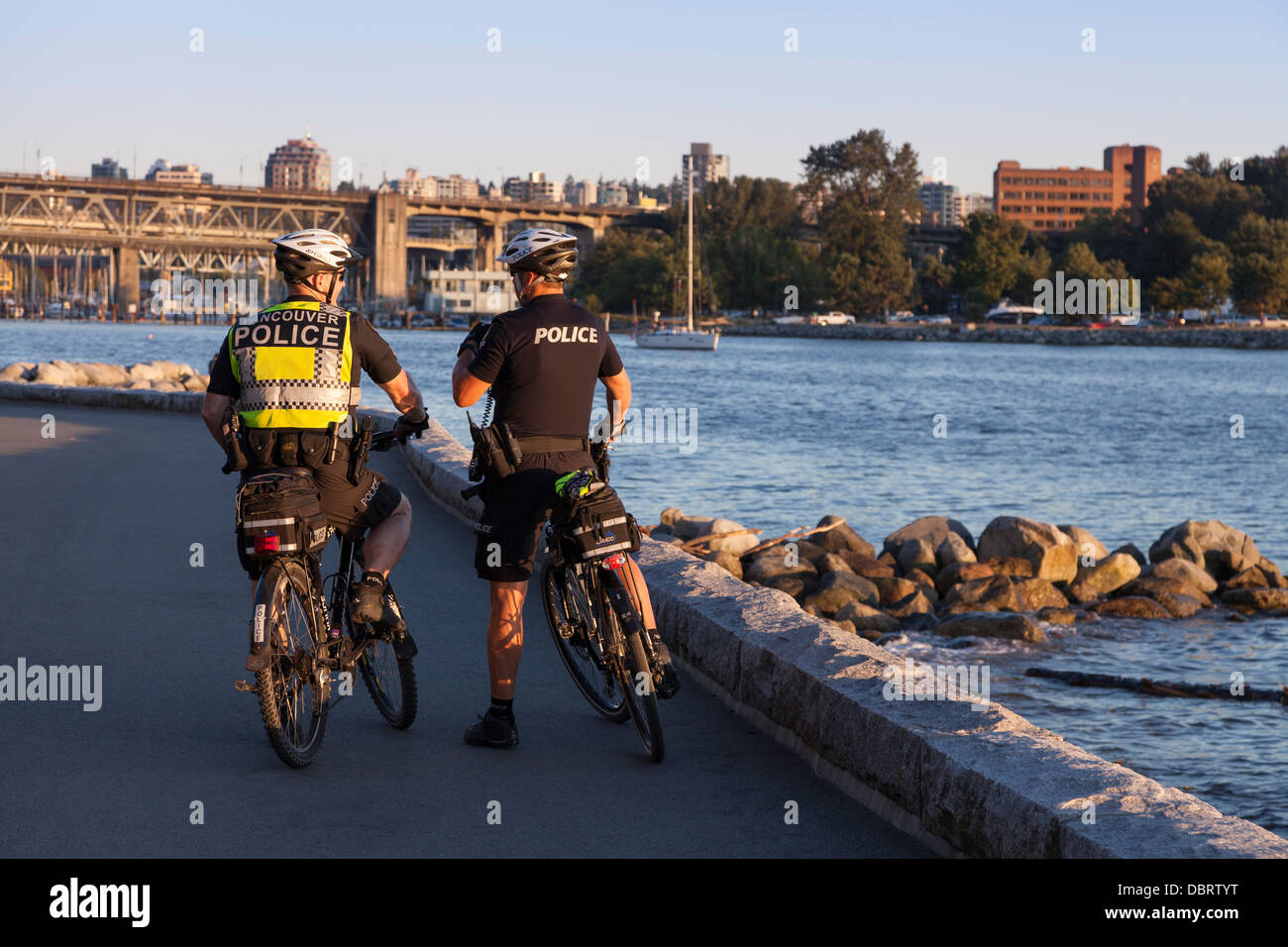 Police officers on community patrol along Sunset Beach Park - West End, Vancouver, British Columbia, Canada Stock Photo