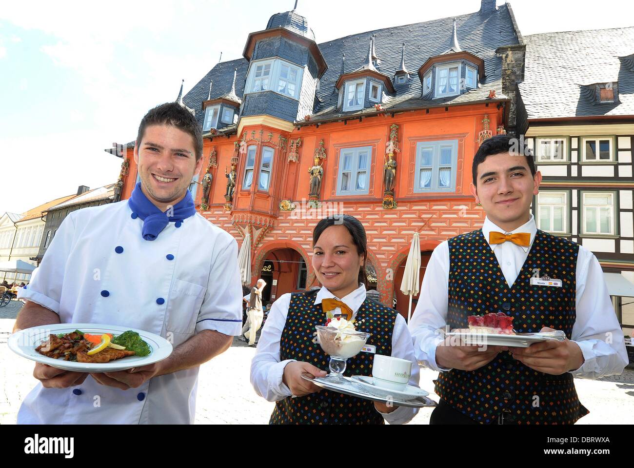 David Delgado (L-R), Iyedjda Corvo-Torres and Nicola Meza from Spain pose at Hotel Kaiserworth in Goslar, Germany, 01 August 2013. Corvo-Torres is one of seven gastronomy interns at the hotel. The internship is one year long. Photo: HOLGER HOLLEMANN Stock Photo