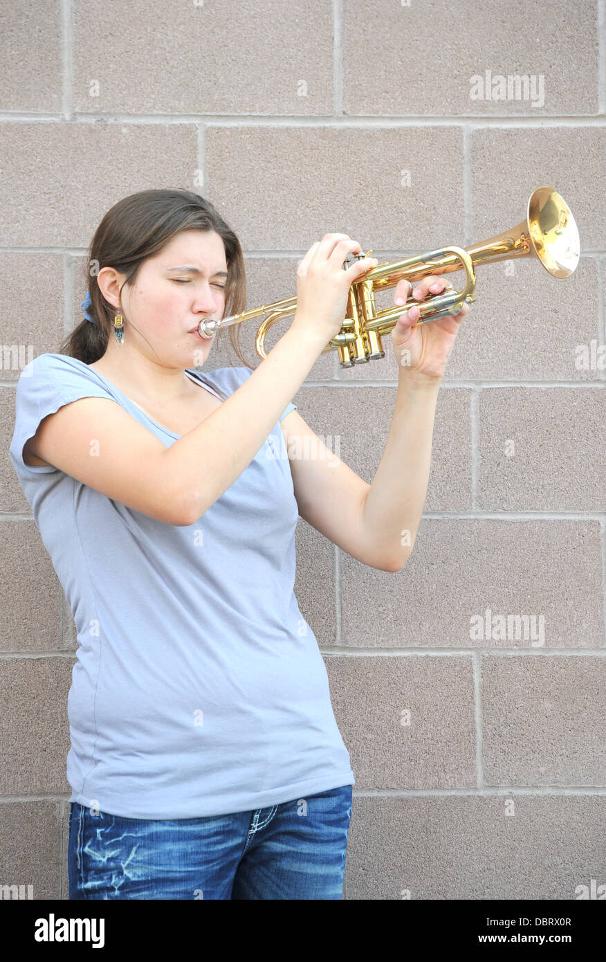 Female blowing her trumpet. Stock Photo