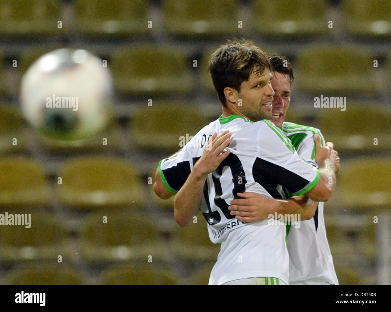 Karlsruhe, Germany. 03rd Aug, 2013. Wolfsburg's Diego Ribas da Cunha (L) and Christian Traesch celebrates the Diego's 0-2 goal during the first round DFB Cup match between Karlsruher SC and VfL Wolfsburg at Wildpark stadium in Karlsruhe, Germany, 03 August 2013. Photo: Uli Deck/dpa/Alamy Live News Stock Photo