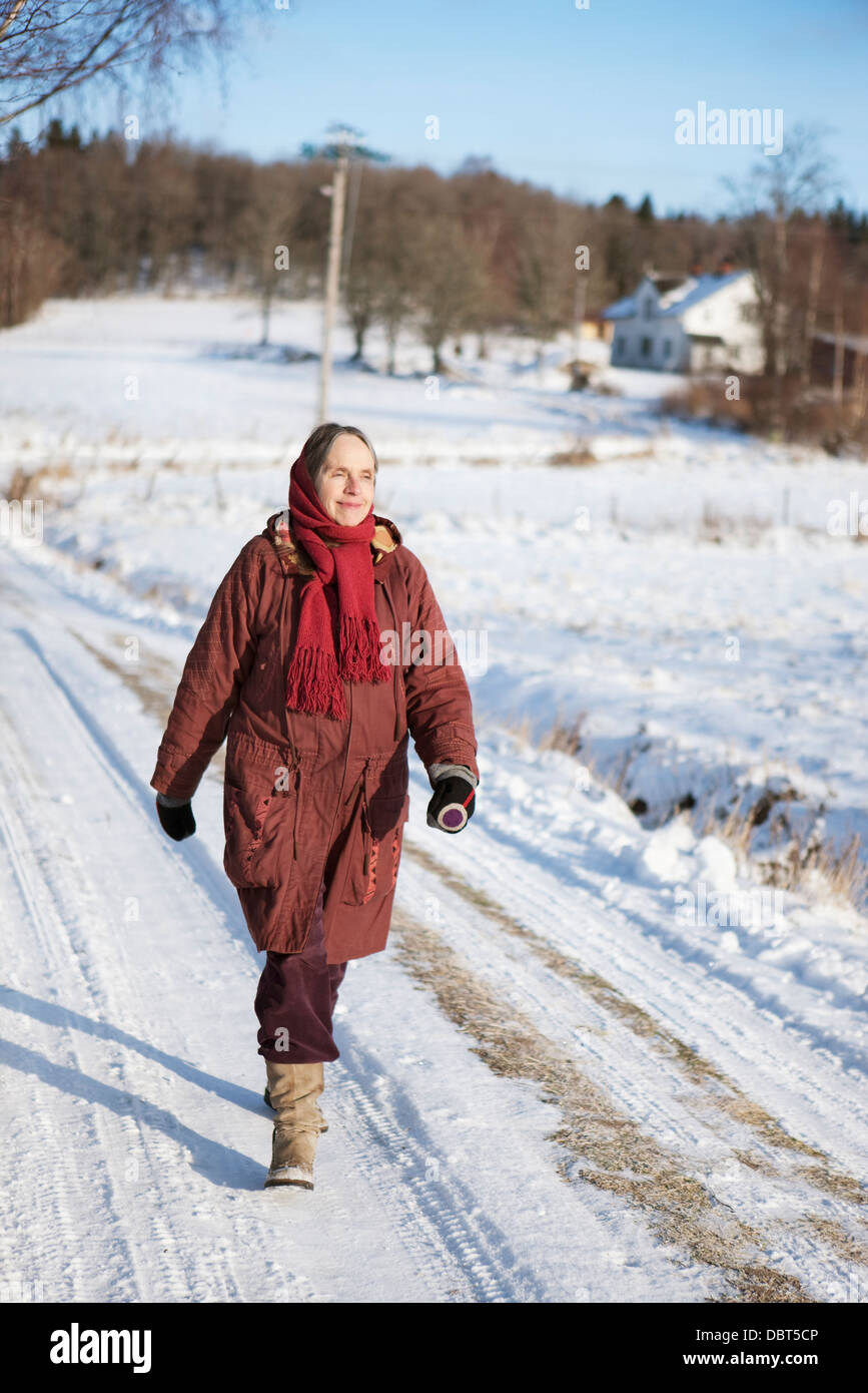 Woman walking along the road hi-res stock photography and images - Alamy