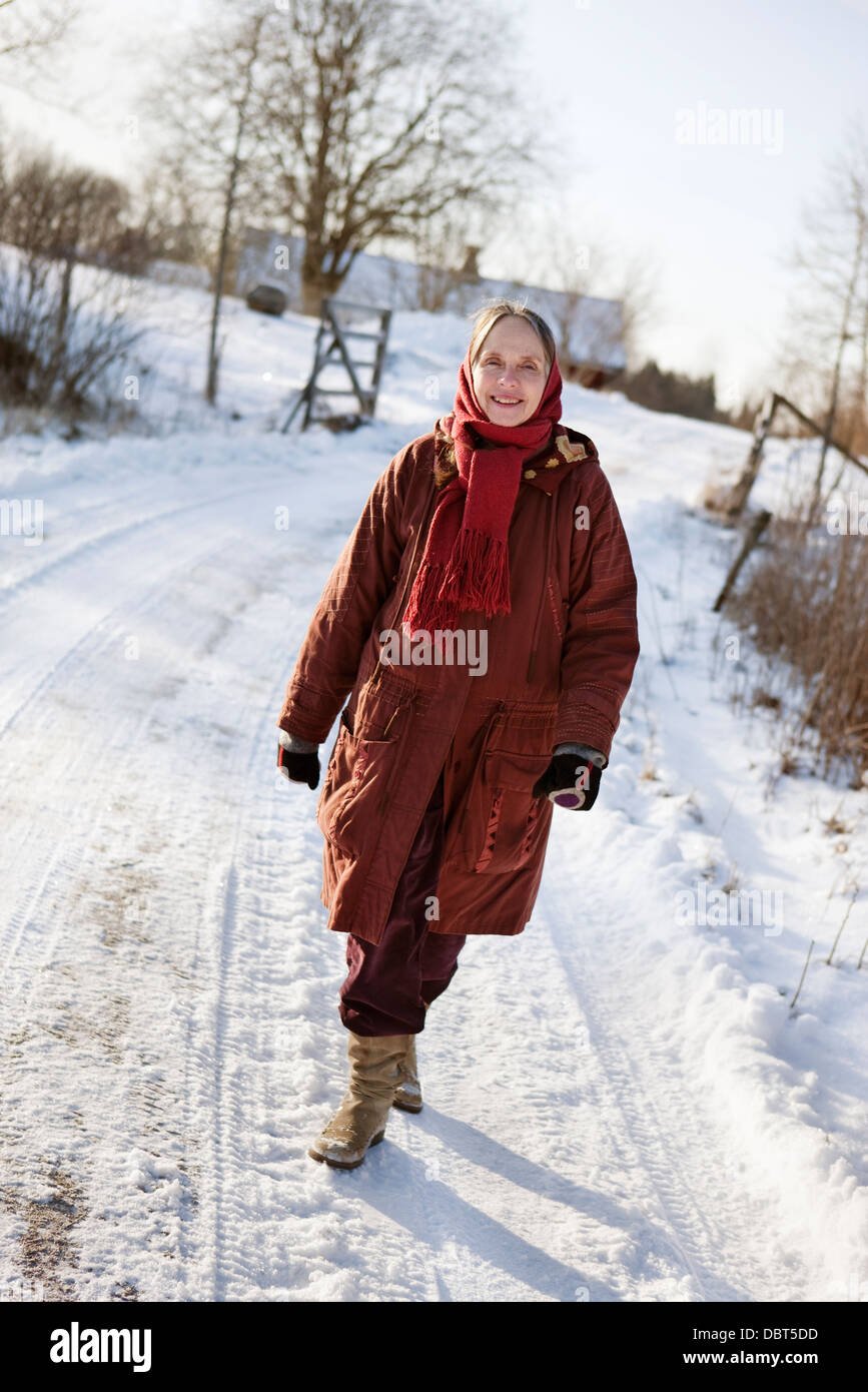 Woman walking along the road hi-res stock photography and images - Alamy