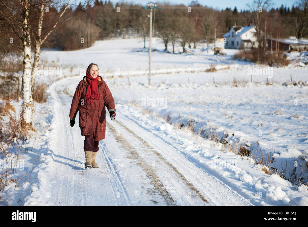Woman walking along the road hi-res stock photography and images - Alamy