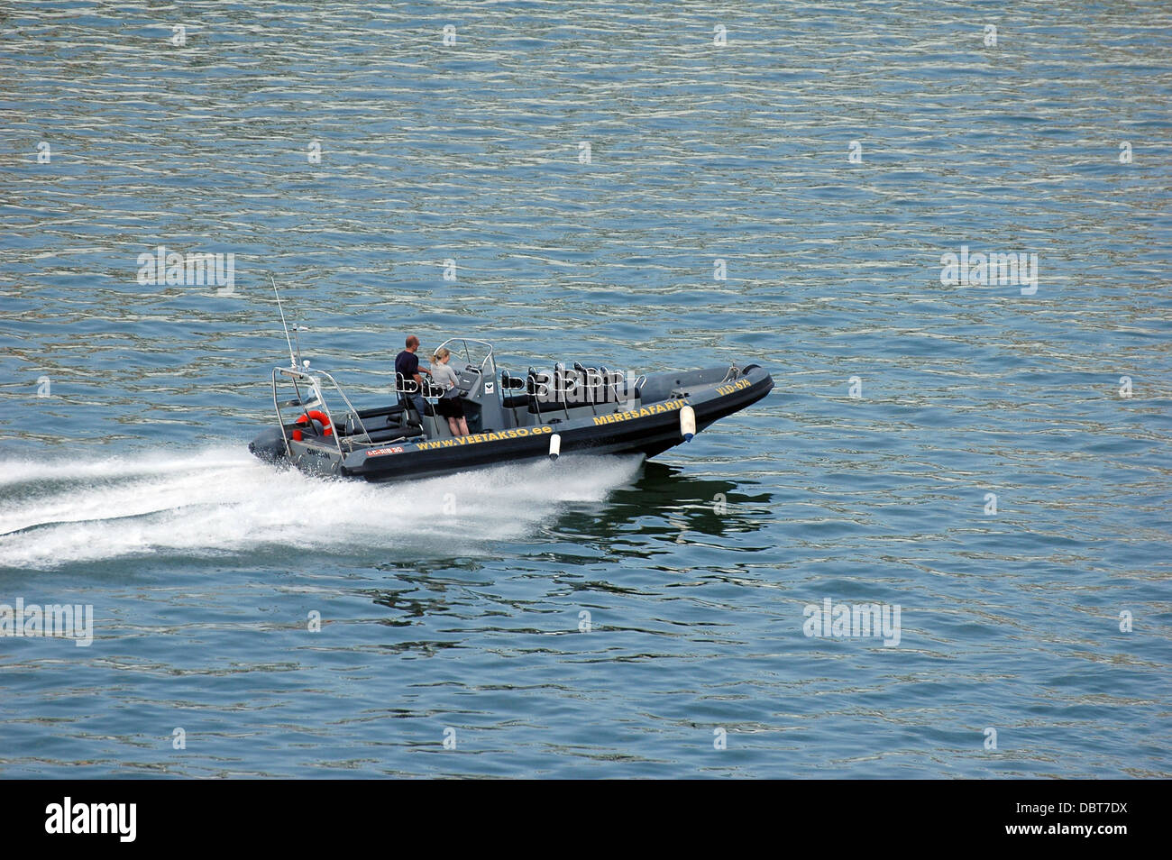 man and woman on motorboat at Baltic Sea Stock Photo