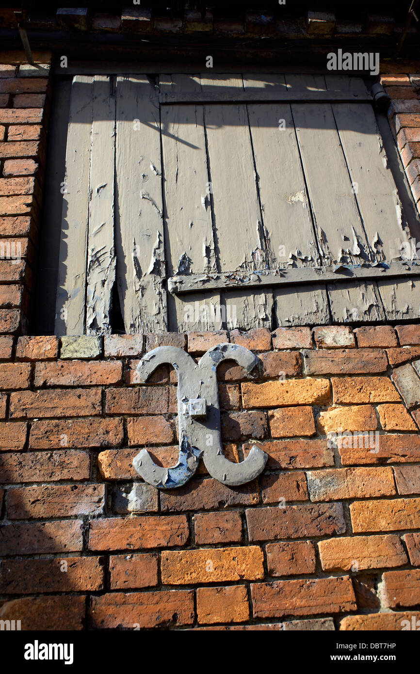 Old wooden door and wall brace in a red brick wall Braunston village