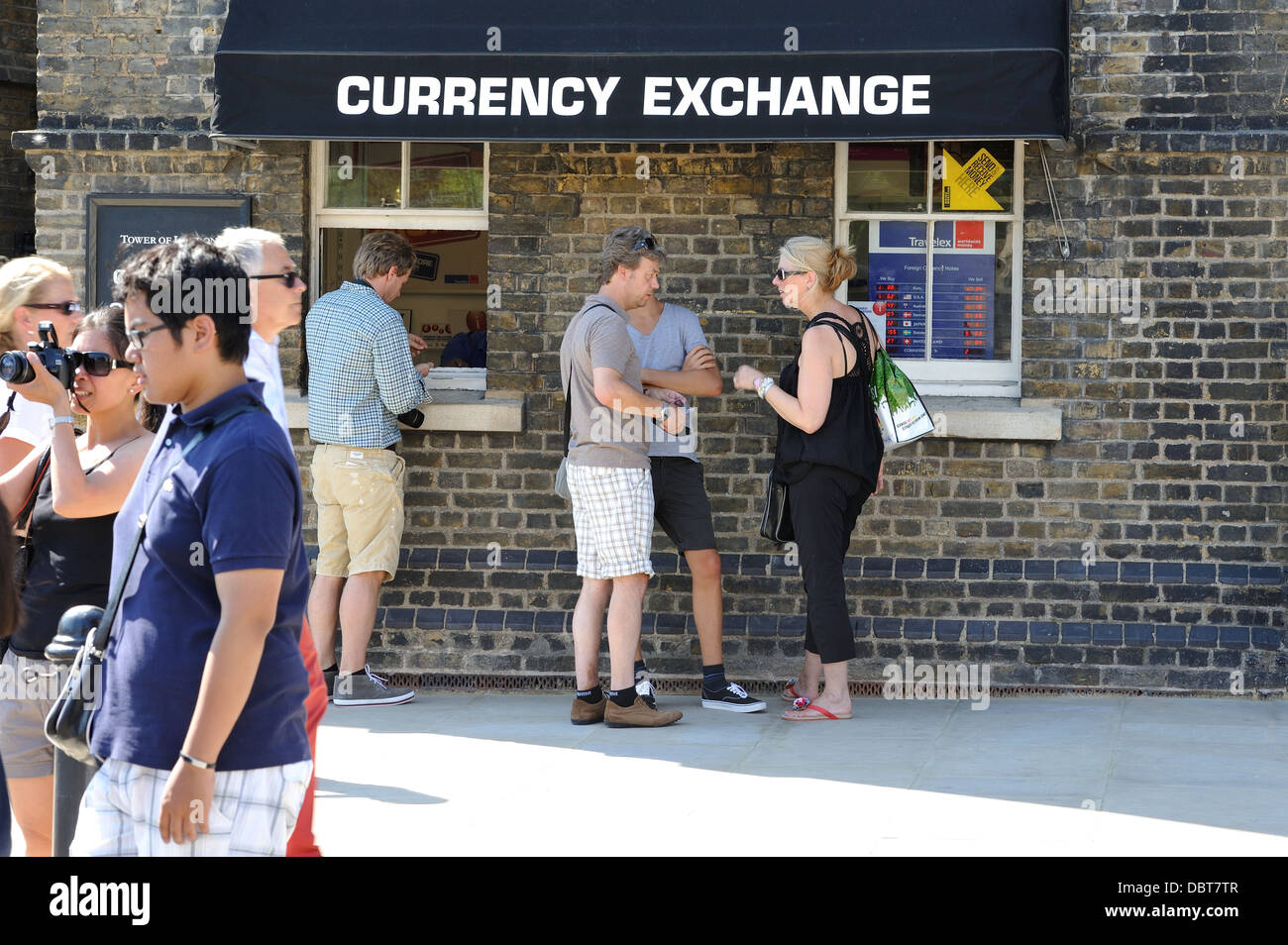 People outside currency exchange Tower Hill London Stock Photo