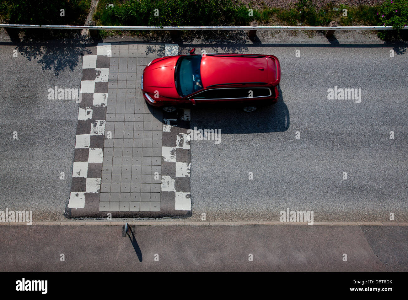 Elevated view of car on road with speed bump Stock Photo