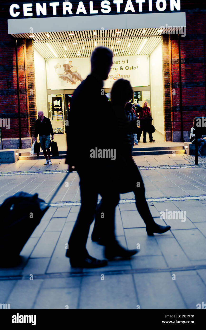 Silhouette of people in front of entrance to railroad station Stock Photo