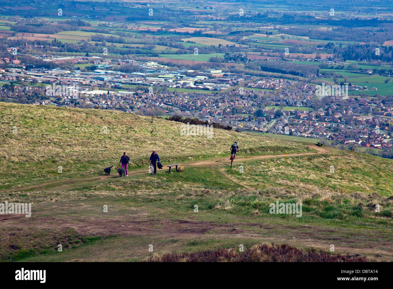 Dog walkers and a cyclist below Worcestershire Beacon on the Malvern