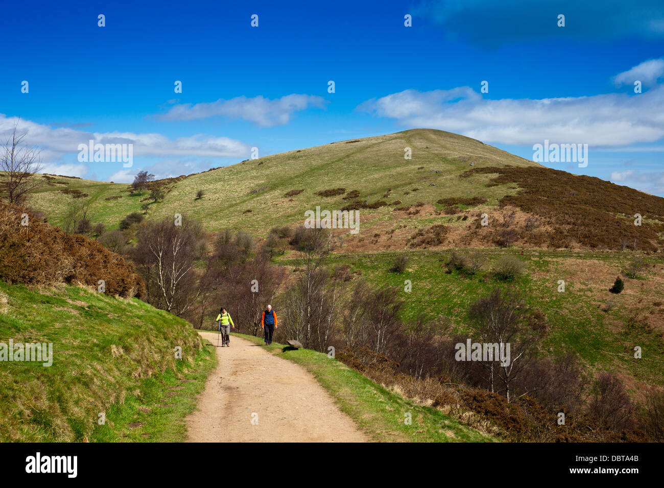 Looking towards two walkers and North Hill in the Malvern Hills, Hereford & Worcestershire, England, UK Stock Photo