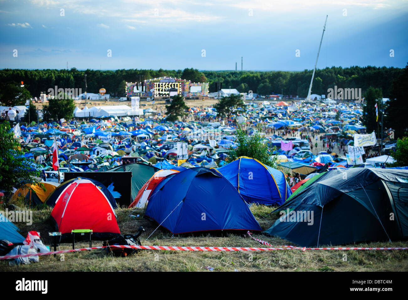 View of the crowded campsite in front of the main stage during the Przystanek Woodstock, Kostrzyn, Poland. Stock Photo