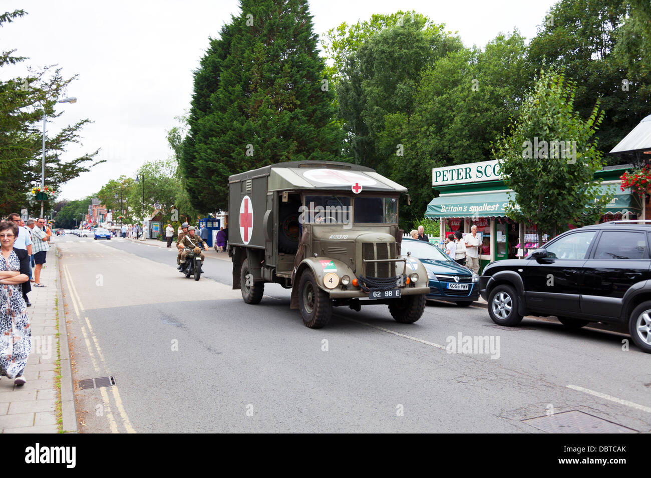 Woodhall Spa. 4th August, 2013. Woodhall Spa 1940's weekend 4/08/2013 Lincolnshire Village UK England. British army ambulance speeding down road  traditional 1940's war time outfits of the era along with war vehicles and cars Credit:  Paul Thompson Live News/Alamy Live News Stock Photo