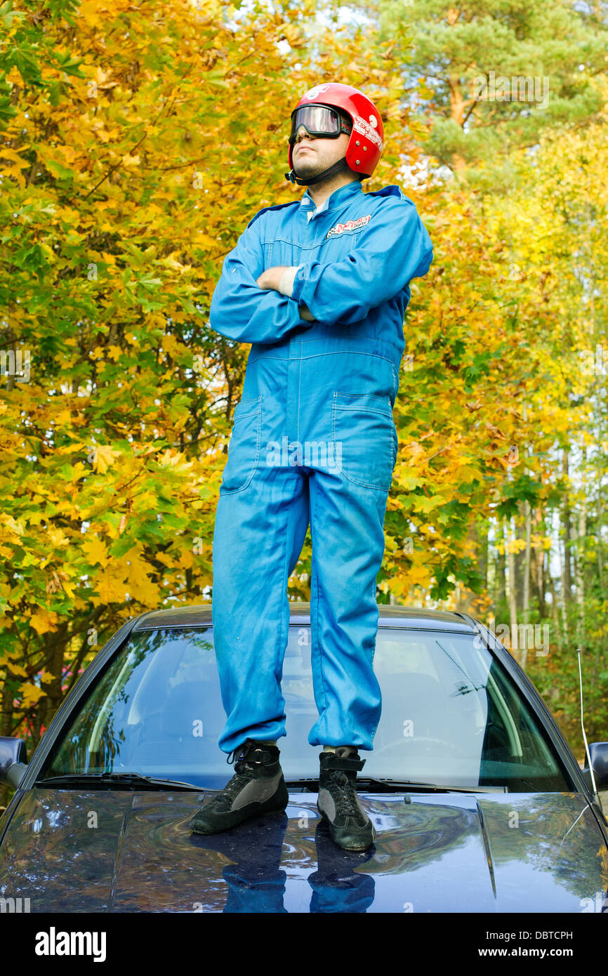 Man standing on car Stock Photo Alamy