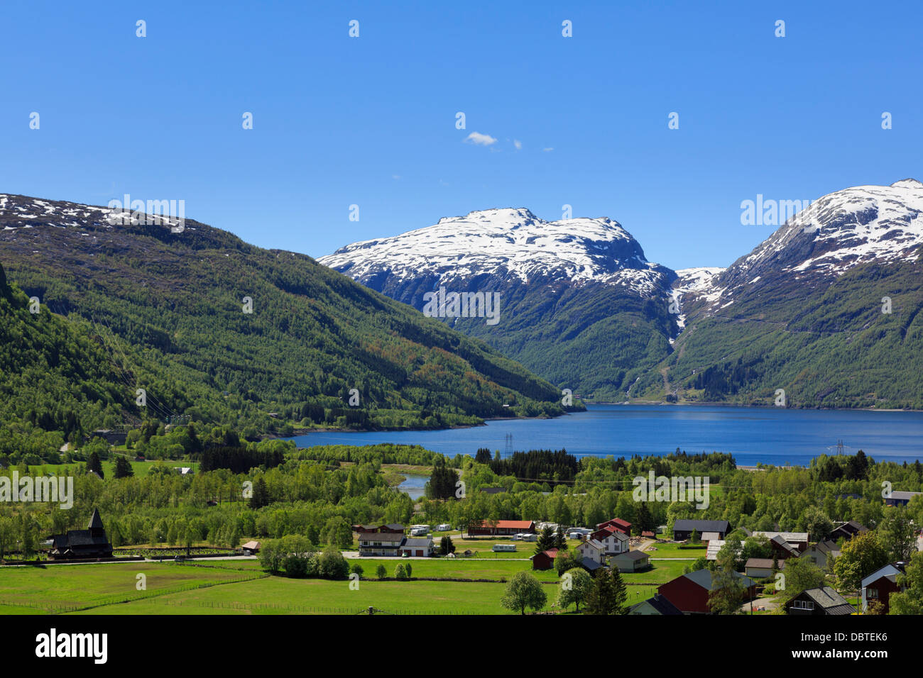 View across valley and lakeside village to Lake Roldalsvatnet in summer ...
