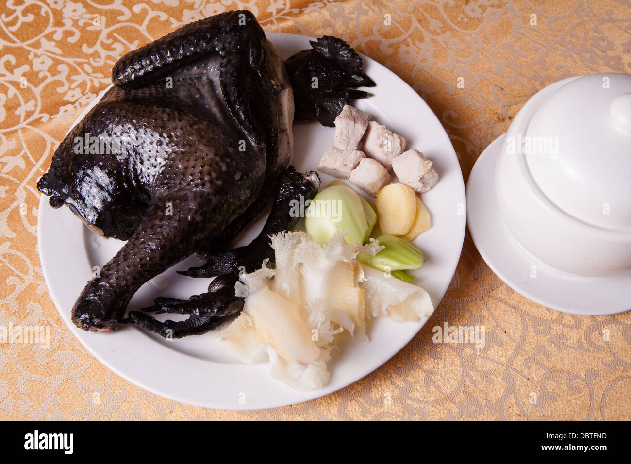 black chicken jellyfish and balls on a white plate Stock Photo